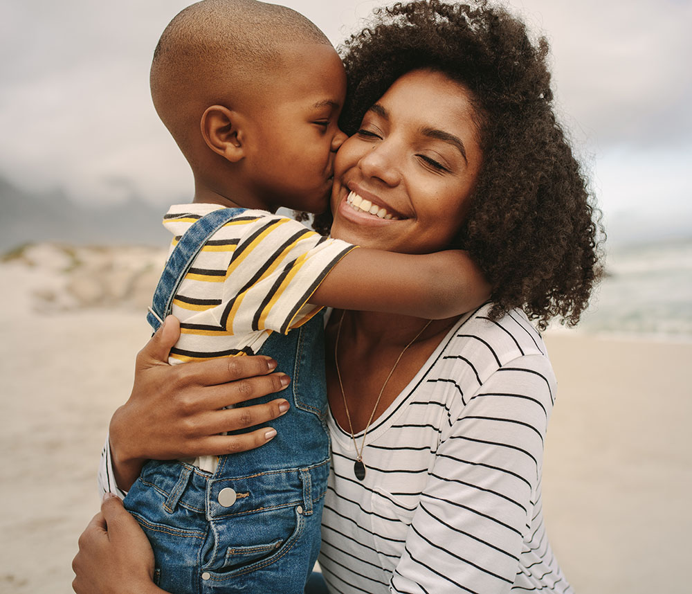 Boy enjoying at day out with his mother on the beach